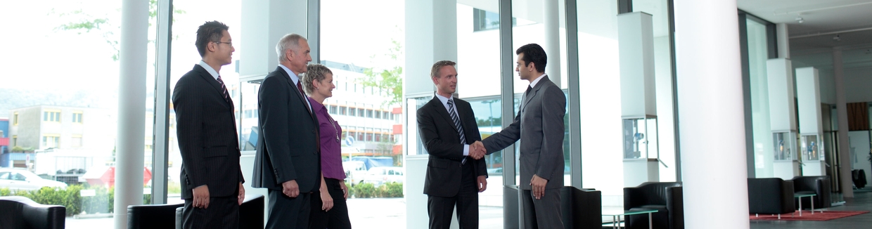 Employee and customer shaking hands in the lobby